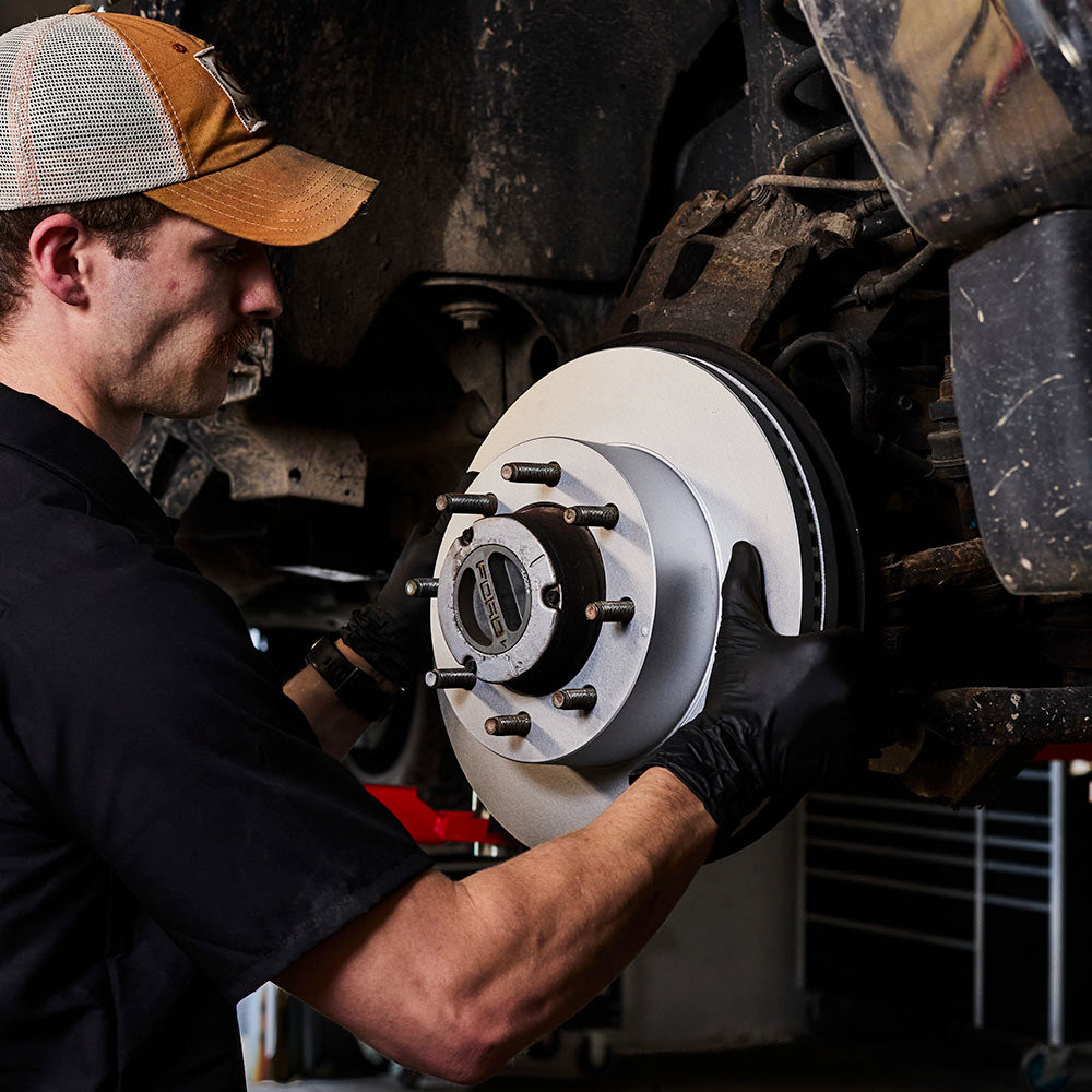 Doc's Diesel High Carbon Brake Rotors being placed on to a car lifestyle