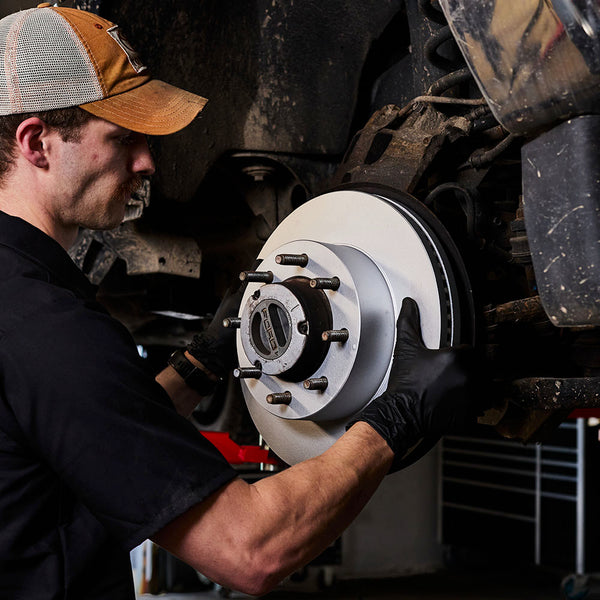 Doc's Diesel High Carbon Brake Rotors being placed on to a car lifestyle