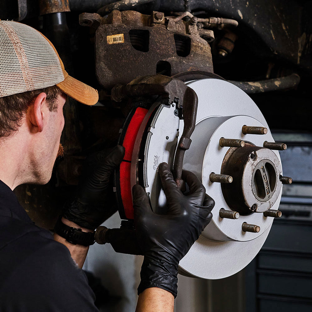 Doc's Diesel High Carbon Brake Rotors being placed on to a car lifestyle