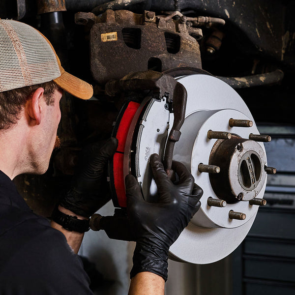 Doc's Diesel High Carbon Brake Rotors being placed on to a car lifestyle