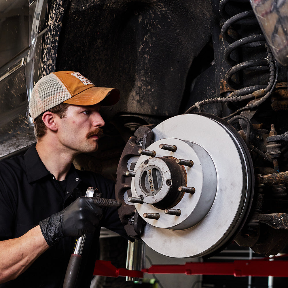 Doc's Diesel High Carbon Brake Rotors being placed on to a car lifestyle