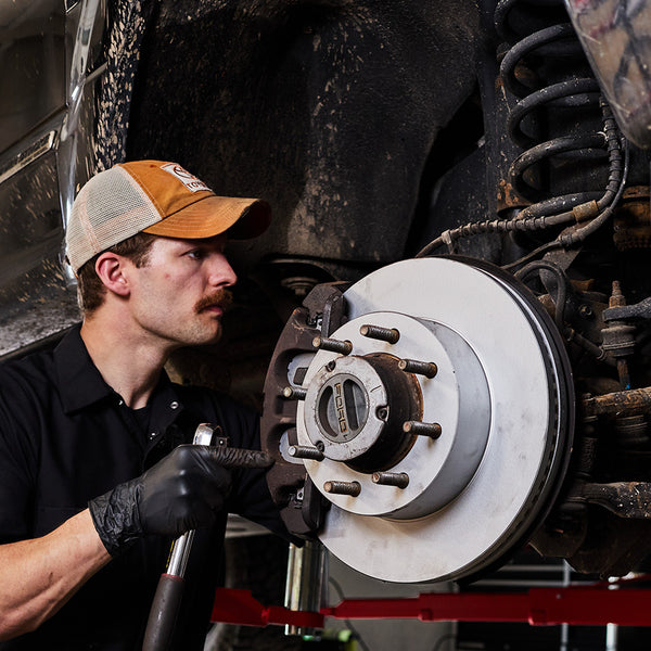 Doc's Diesel High Carbon Brake Rotors being placed on to a car lifestyle