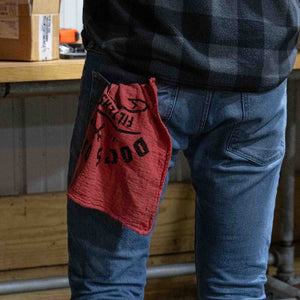 Doc's Diesel Shop Rag 14" x 14" hanging out of the back pocket of a working man in jeans