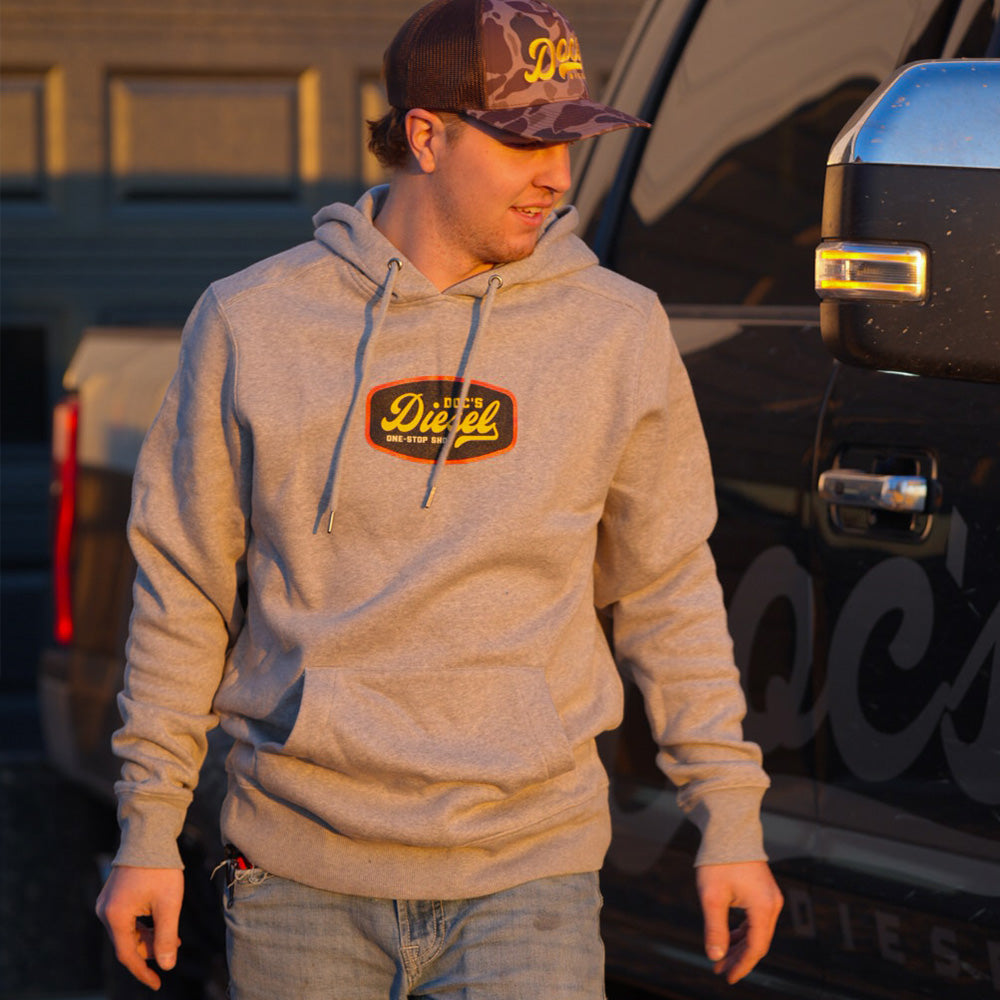 Doc's Diesel Light Grey Shop Hoodie on a man wearing a Doc's Diesel Camo Trucker Hat