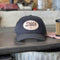 Doc's Diesel Staple Snapback Hat on a work counter